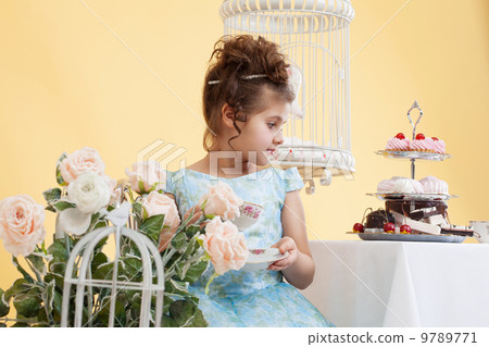 Shot of cute little lady drinking tea in studio 9789771