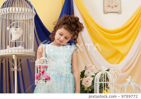 Adorable little girl posing in decorated studio 9789772