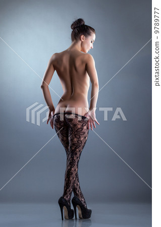 Seductive nude woman posing in translucent tights Seductive nude woman posing in translucent tights 9789777