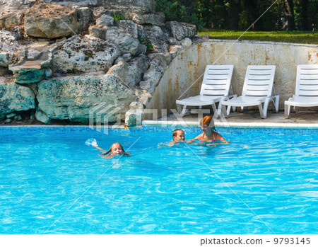 Mother train children to swim in the pool. Mother train children to swim in the pool. 9793145