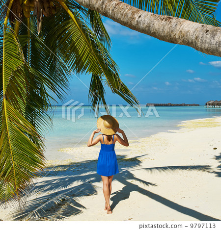 Woman in blue dress on a beach at Maldives 9797113