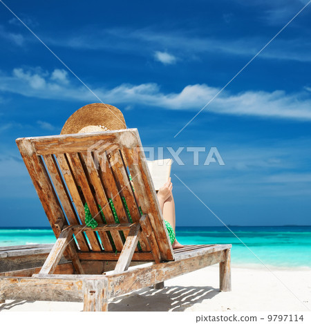 Young woman reading a book at beach 9797114