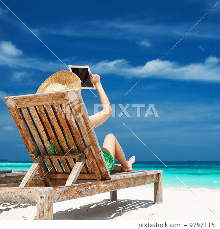 Young woman with tablet pc at the beach 9797115
