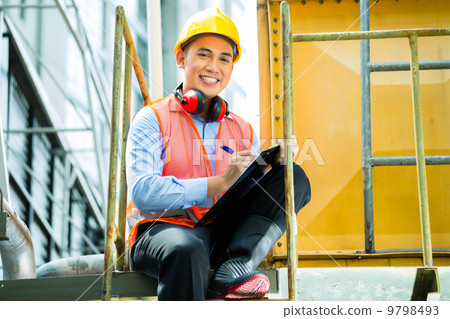 Asian Indonesian construction worker on building site 9798493