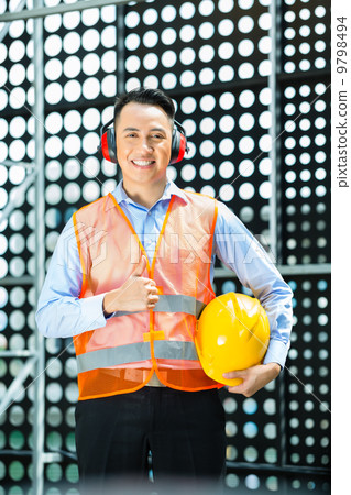 Asian Indonesian construction worker on building site 9798494