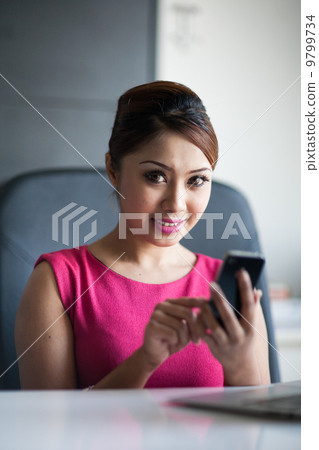 Playing phone at the office 9799734