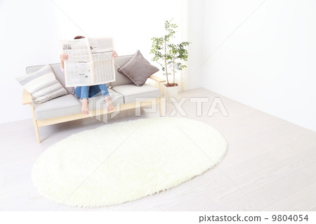 A woman reading a newspaper 9804054