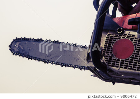Man sawing a log in his back yard 9806472