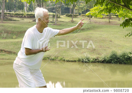 asian senior performing taichi 9808720