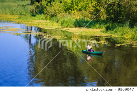 Man Fishing Out Of A Row Boat 9809047