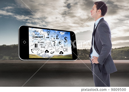 Composite image of serious businessman with hands on hips 9809500