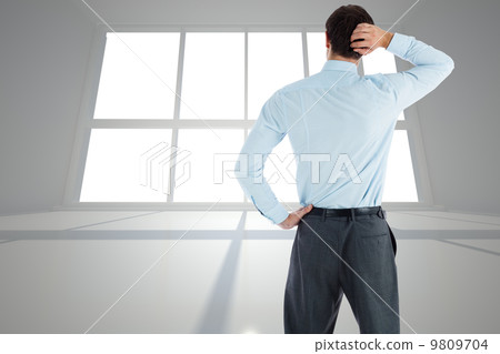 Composite image of thinking businessman with hand on head Composite image of thinking businessman with hand on head 9809704