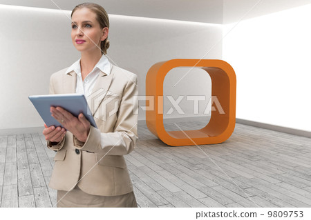 Composite image of pensive stylish businesswoman holding tablet Composite image of pensive stylish businesswoman holding tablet 9809753