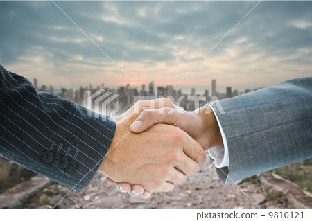 Composite image of business handshake Composite image of business handshake 9810121