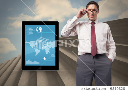 Composite image of thinking businessman touching his glasses 9810820