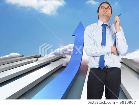 Composite image of thinking businessman holding pen 9810907