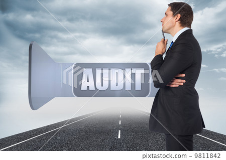 Composite image of thinking businessman holding pen 9811842