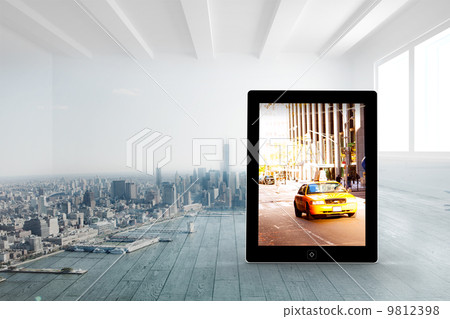 Composite image of yellow taxi on tablet screen 9812398