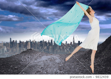 Composite image of young beautiful female dancer with blue scarf 9812439