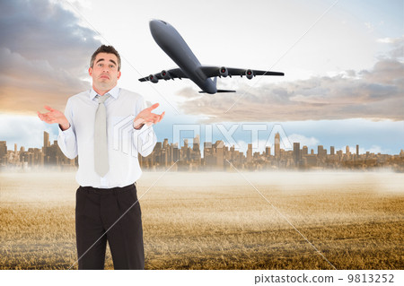 Composite image of portrait of a clueless businessman posing Composite image of portrait of a clueless businessman posing 9813252