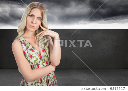 Composite image of frowning pretty blonde wearing flowered dress Composite image of frowning pretty blonde wearing flowered dress 9813317