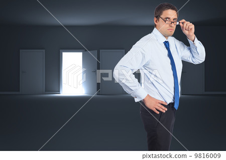 Composite image of thinking businessman tilting glasses Composite image of thinking businessman tilting glasses 9816009