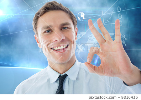 Composite image of businessman showing ok sign 9816436