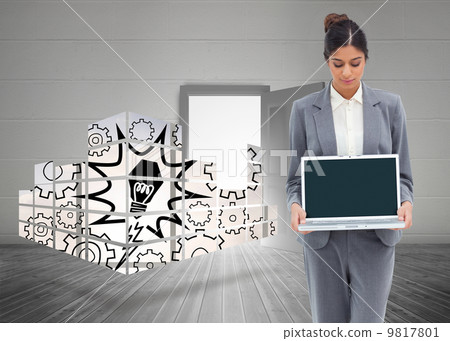 Composite image of businesswoman looking at laptop in her hands 9817801