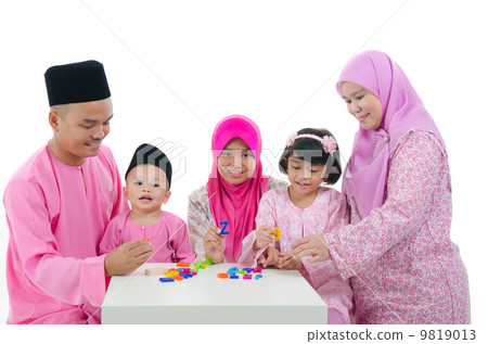 malay family playing and having quality time during hari raya 9819013