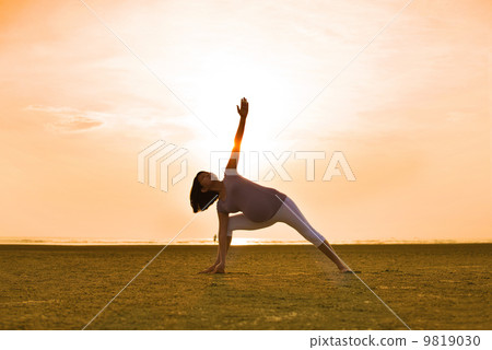 pregnant mother performing yoga on outdoor beach pregnant mother performing yoga on outdoor beach 9819030