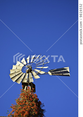 Wind mill against a blue sky 9819332