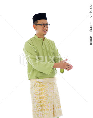 Malay male greetings during ramadan festival with isolated white Malay male greetings during ramadan festival with isolated white 9819382