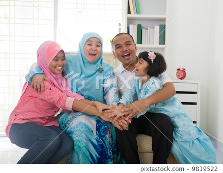 Excited Southeast Asian family at home. Muslim family living lif Excited Southeast Asian family at home. Muslim family living lif 9819522