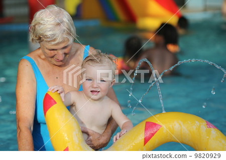 healthy senior woman is enjoying time with her adorable one year old grandchild healthy senior woman is enjoying time with her adorable one year old grandchild 9820929