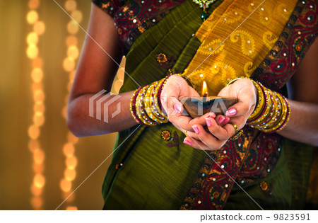 diwali or deepavali photo with female holding oil lamp during fe 9823591