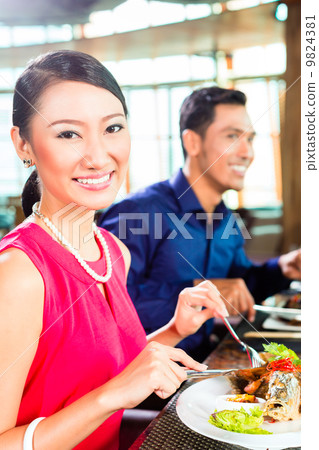 Asian people fine dining in restaurant 9824381