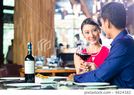 Asian couple fine dining in restaurant Asian couple fine dining in restaurant 9824382