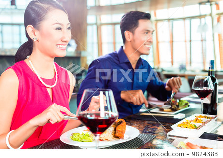 Asian people fine dining in restaurant 9824383