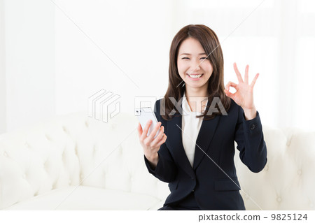 Woman business watching smartphone 9825124