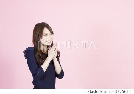 A young woman with a smile to put your hands together and ask 9825651