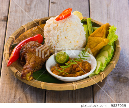 indonesian fried chicken rice on traditional background indonesian fried chicken rice on traditional background 9827039