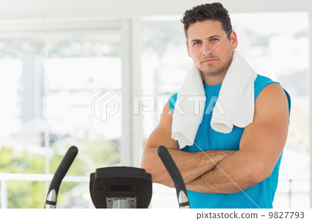 Serious young man working out at spinning class Serious young man working out at spinning class 9827793