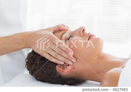 Woman receiving head massage 9827985