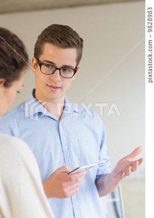 Business people communicating over mobile phone 9828983