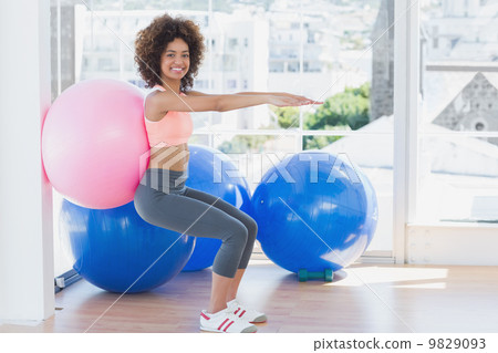 Sporty woman with exercise ball in fitness studio 9829093