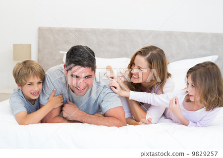 Playful family in bed Playful family in bed 9829257