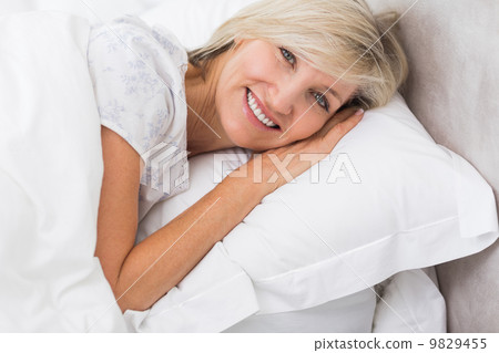Portrait of a mature woman resting in bed Portrait of a mature woman resting in bed 9829455