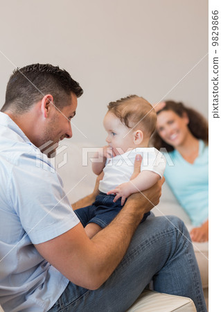 Happy man playing with baby 9829866