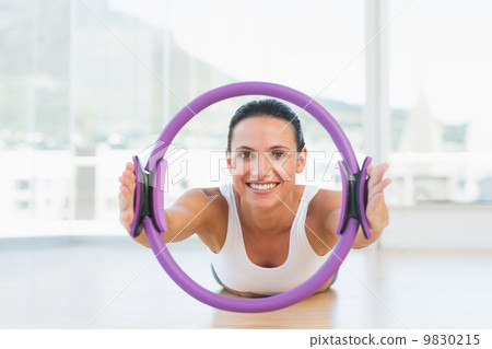 Sporty woman with exercise ring in fitness studio 9830215