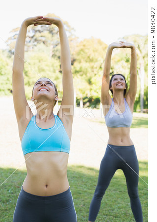 Sporty young women exercising 9830422